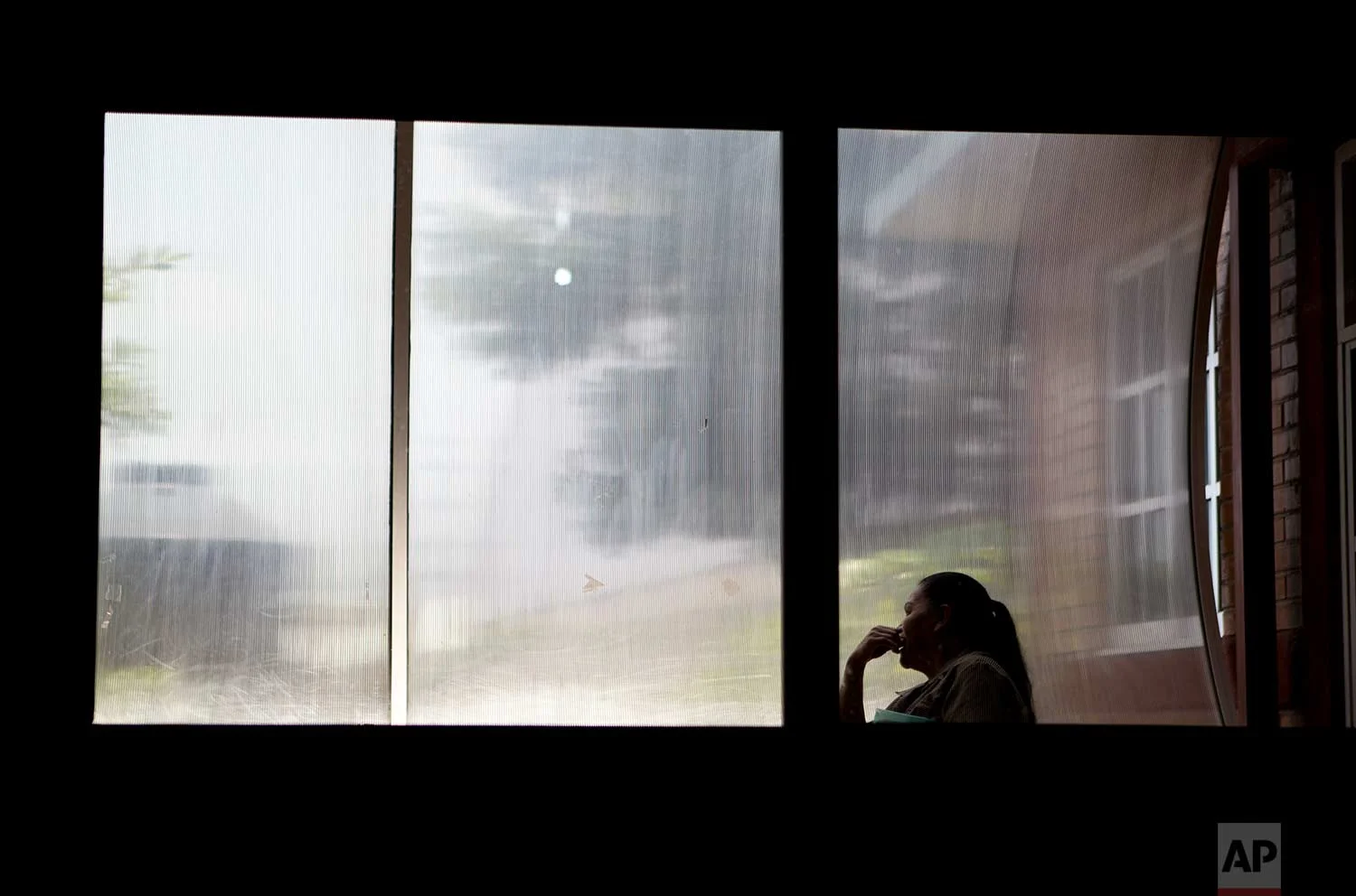 In this Aug. 15, 2007 photo, a woman sits in front of a window inside a nursing school in Nezahualcoyotl, Mexico state. The nonprofit Citizen Observatory Against Gender Violence, Disappearance and Femicides in Mexico State counted 263 femicides in 2016 alone. (AP Photo/Rebecca Blackwell)