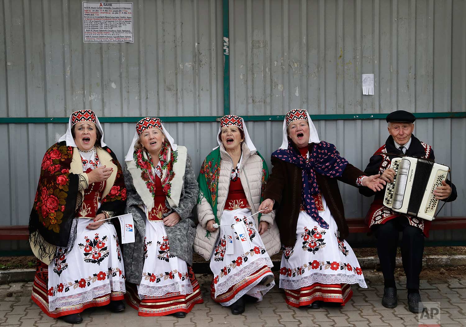  Women wearing Belarusian traditional clothing sing a song as they take part in a national festival marking the end of harvest collection in the town of Smolevichi, Belarus, 30 kilometers (19 miles) east of the capital Minsk, on Saturday, Oct. 7, 201