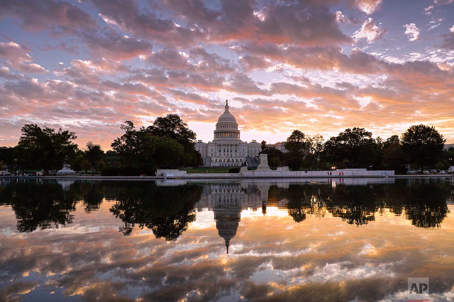  The sun rises above the U.S. Capitol building in Washington on Tuesday, Oct. 10, 2017. (AP Photo/J. Scott Applewhite) 