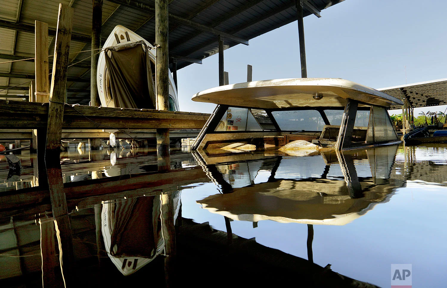 A boat is submerged in a Hurricane Harvey-damaged marina in Beaumont, Texas, Wednesday, Sept. 27, 2017. The marina's waters rose so high that several boats crashed through the high tin roofs above their slips. Jefferson County was drowned by more than 60 inches of rain during Hurricane Harvey, the most rainfall ever recorded in a single storm in the nation's history, according to preliminary data from the National Weather Service. (AP Photo/David Goldman)