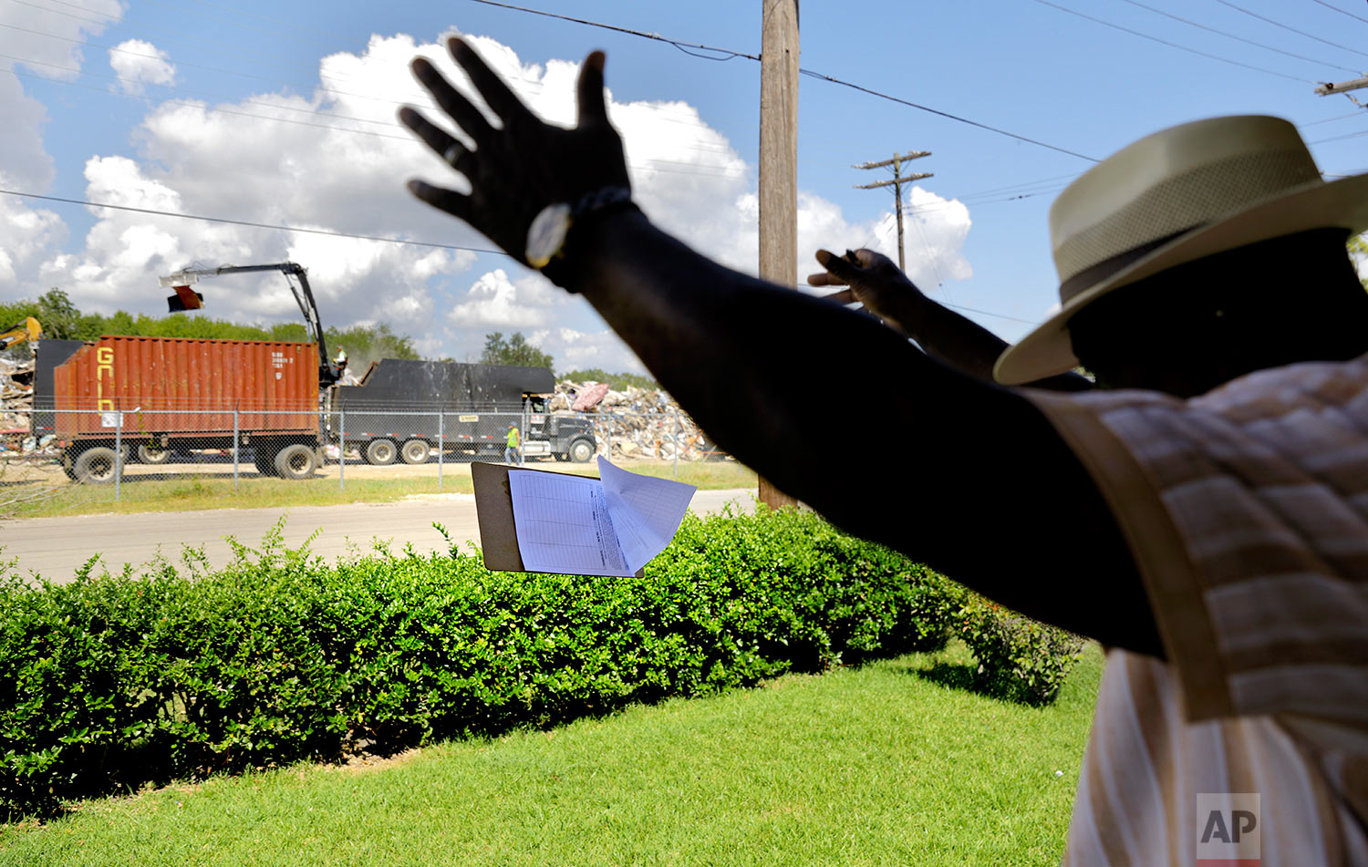  Hilton Kelley tosses his petition clipboard in frustration as he's turned away from a renter who was told by her landlord not to get involved in Kelley's attempt to shutdown the dump across the street piled with flood damaged debris in Port Arthur, 