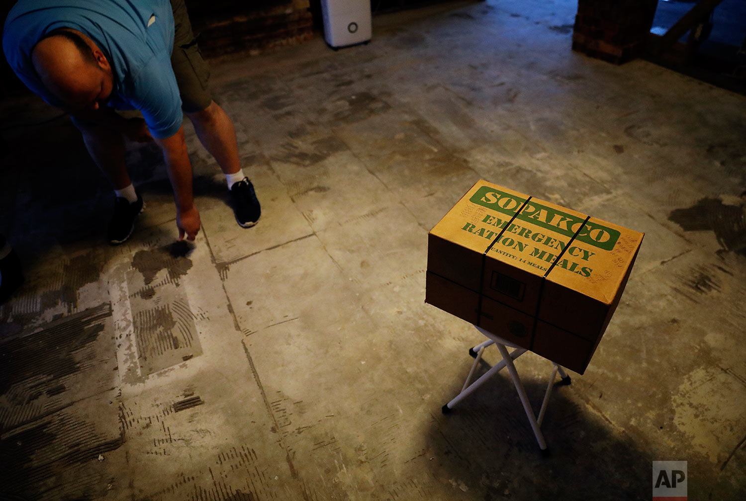  A box of emergency ration meals sits on what used to be the kitchen floor as Wilton Johnson works in his gutted home in Beaumont, Texas, Monday, Sept. 25, 2017, damaged by Hurricane Harvey. (AP Photo/David Goldman) 