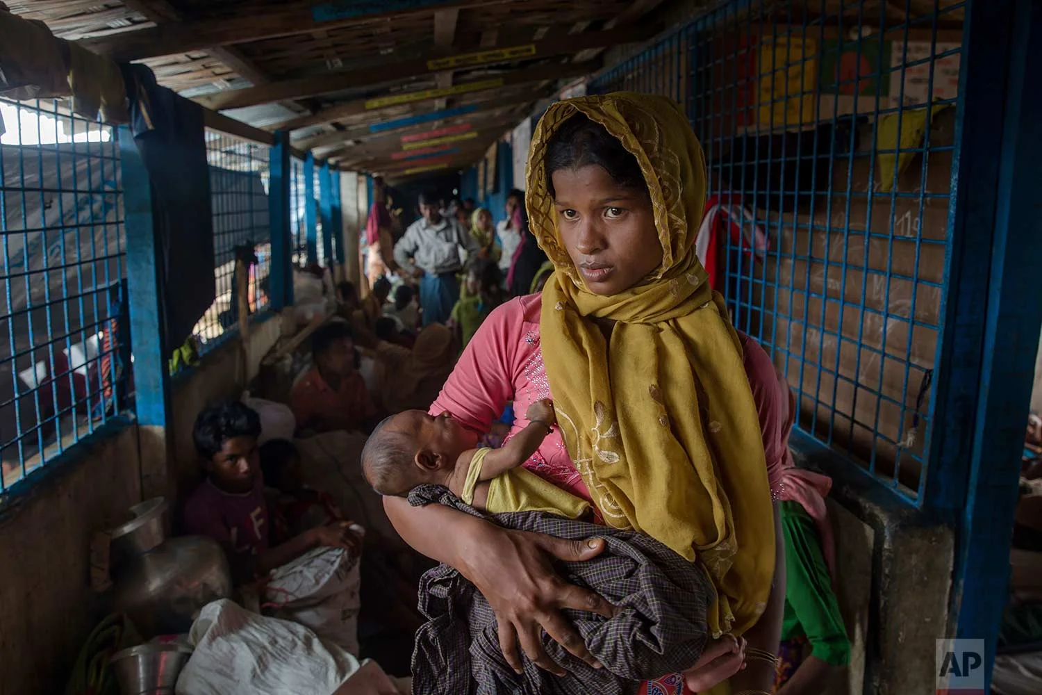 A Rohingya Muslim woman Setara Begum, who crossed over from Myanmar into Bangladesh, holds her 45-day-old son Mohammad Hussain in a dormitory of a school in Kutupalong refugee camp, Bangladesh, Friday, Oct. 20, 2017. (AP Photo/Dar Yasin)