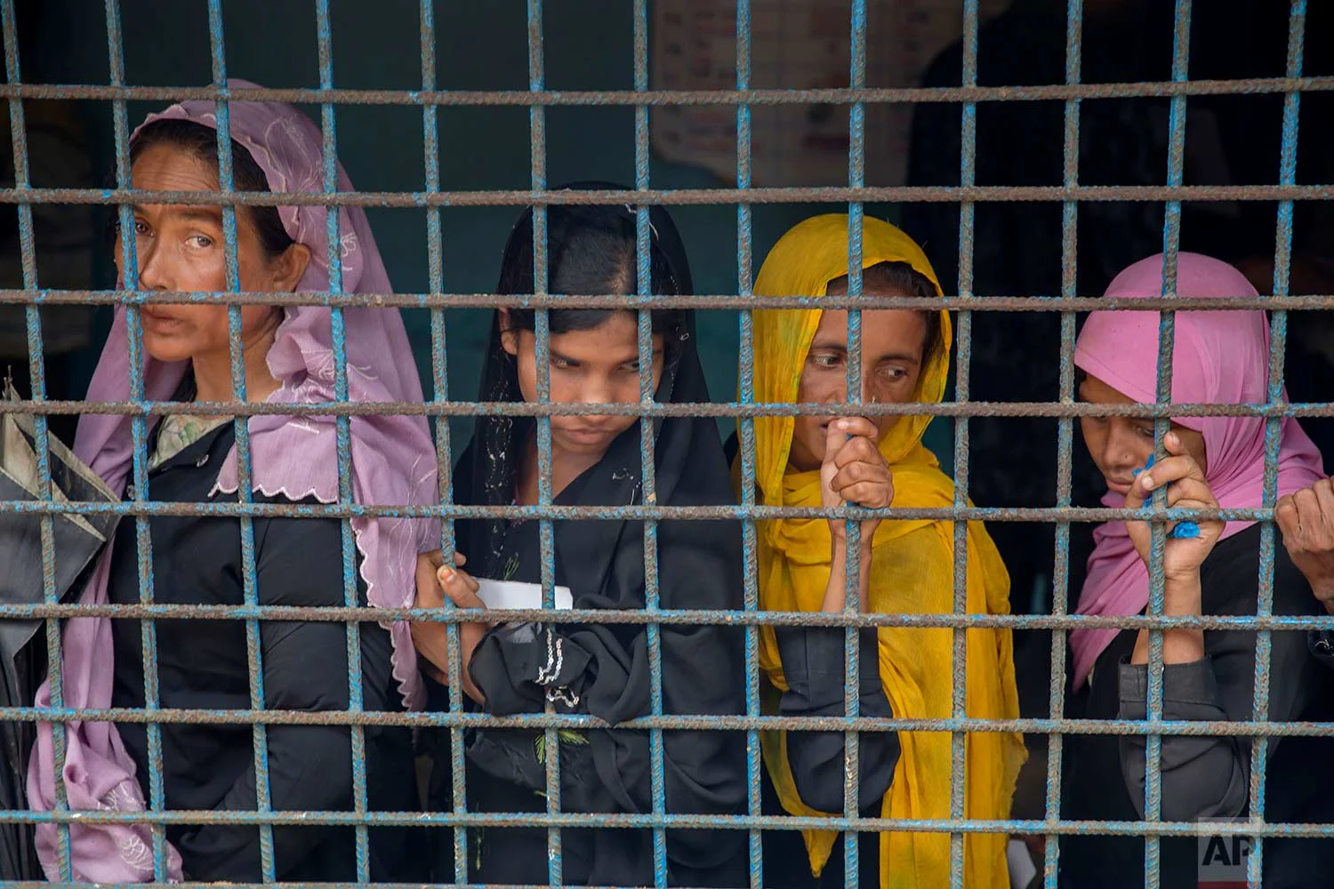 Rohingya Muslim women, who crossed over from Myanmar into Bangladesh, stand in a queue to register themselves as refugees in Kutupalong refugee camp, Bangladesh, Friday, Oct. 20, 2017. AP Photo/Dar Yasin)