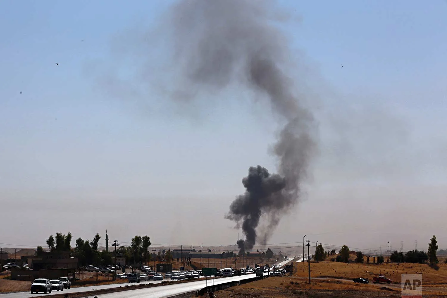 Smoke rises as Iraqi security forces launch explosives as Kurdish security forces withdraw from a checkpoint in Altun Kupri, on the outskirts of Irbil, Iraq, Friday Oct. 20, 2017. (AP Photo/Khalid Mohammed)