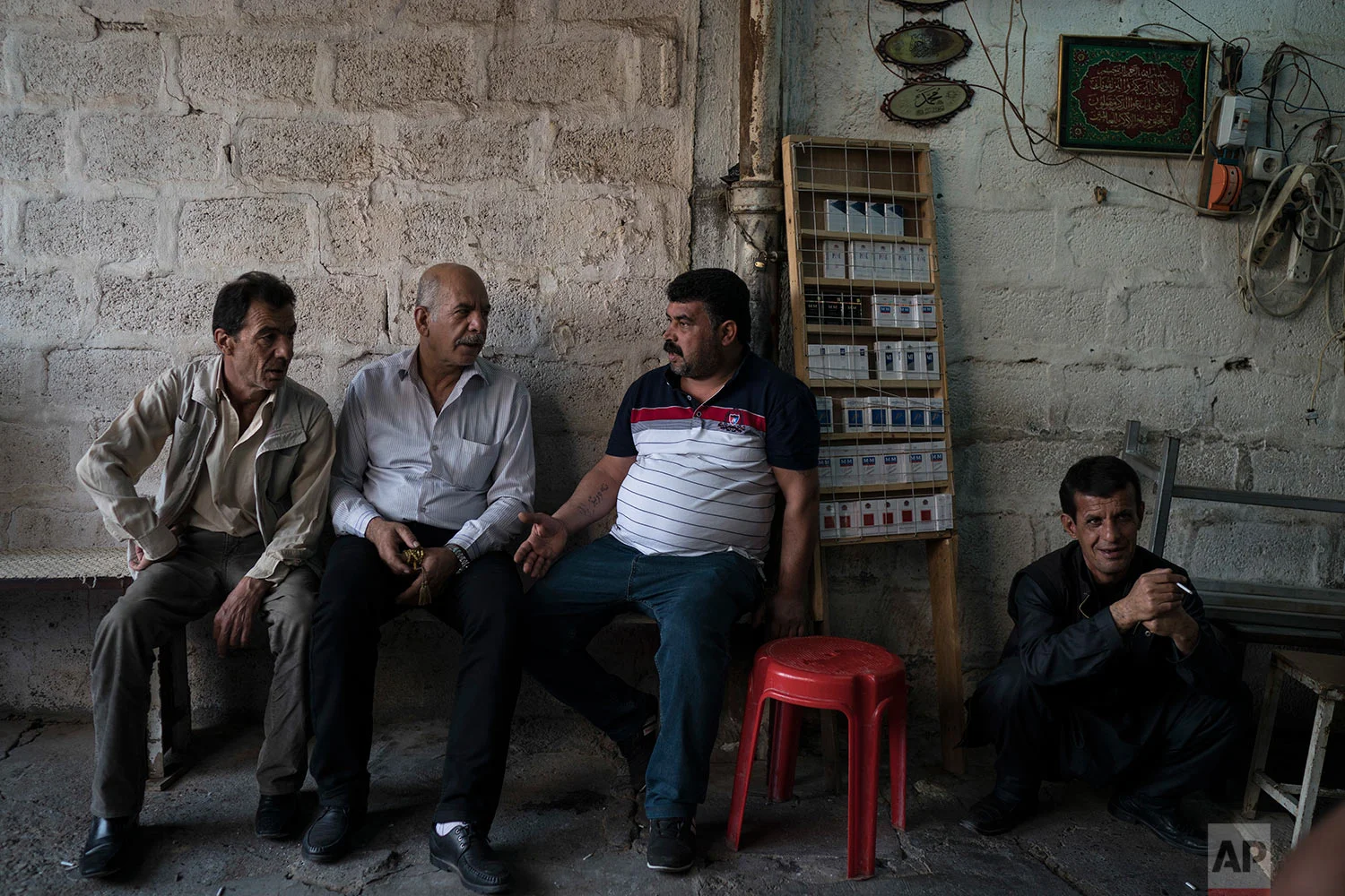 Kurdish men sit outside a tea shop in central Irbil, Iraq, Wednesday, Oct. 25, 2017. In Sept. 2017, Iraq's Kurds celebrated their symbolic vote for independence, but instead of moving forward with negotiations toward a smooth divorce from Baghdad, they have lost their most important oil-producing city to Iraqi troops, squeezing a hurting economy and dashing the hopes of an independent state. (AP Photo/Felipe Dana)