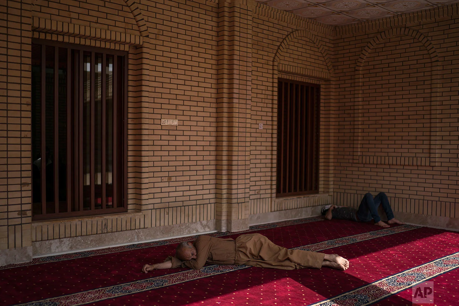 Kurdish men rest outside a mosque in central Irbil, Iraq, Wednesday, Oct. 25, 2017. In Sept. 2017, Iraq's Kurds celebrated their symbolic vote for independence, but instead of moving forward with negotiations toward a smooth divorce from Baghdad, they have lost their most important oil-producing city to Iraqi troops, squeezing a hurting economy and dashing the hopes of an independent state. (AP Photo/Felipe Dana)