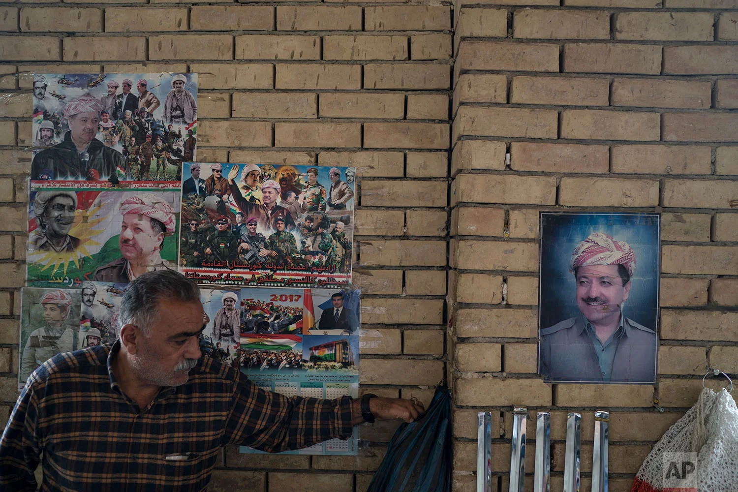 Photos of Kurdish president Masoud Barzani hang on the walls of the central bazaar in Irbil, Iraq, Wednesday, Oct. 25, 2017. In Sept. 2017, Iraq's Kurds celebrated their symbolic vote for independence, but instead of moving forward with negotiations toward a smooth divorce from Baghdad, they have lost their most important oil-producing city to Iraqi troops, squeezing a hurting economy and dashing the hopes of an independent state. (AP Photo/Felipe Dana)