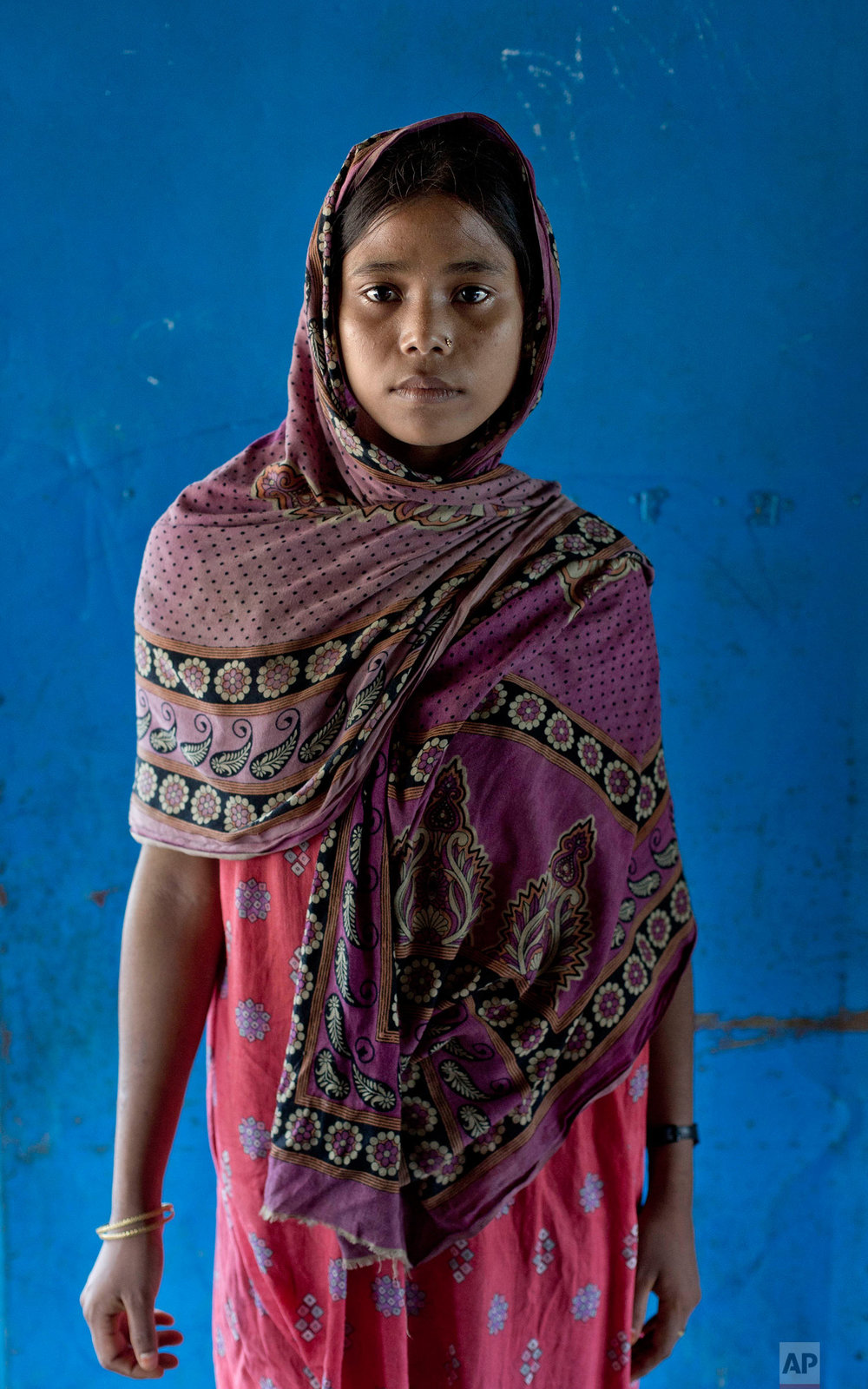  In this Oct. 1, 2017, photo, survivor of a boat capsize Fatima Khatun, from Myanmar's Moidaung Village, stands for a photograph at a transit shelter at Kutupalong camp for newly arrived Rohingya refugees in Bangladesh. Fatima lost her mother and two