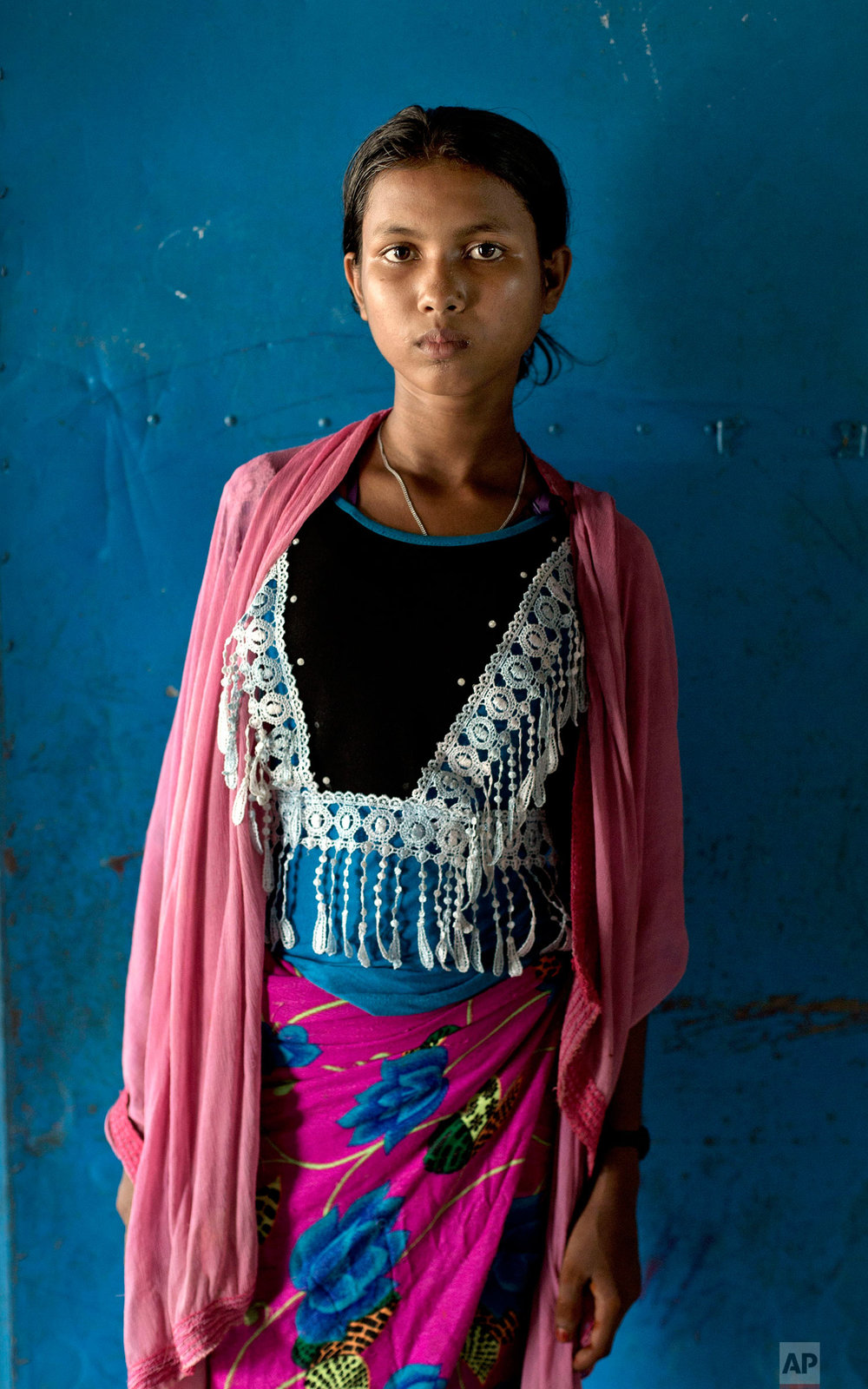  In this Oct. 1, 2017, photo, thirteen-year old survivor of a boat capsize Tosilima, from Myanmar's Moidaung Village, stands for a photograph at a transit shelter at Kutupalong camp for newly arrived Rohingya refugees in Bangladesh. Tosilima's mother