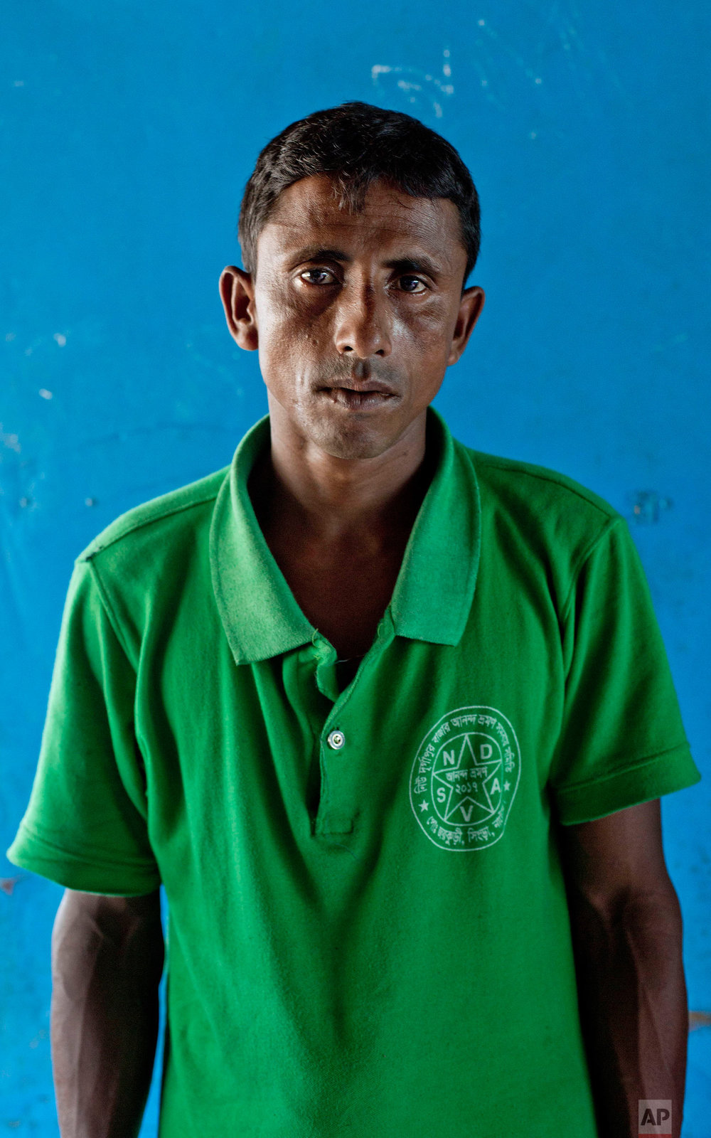  In this Oct. 1, 2017, photo, a Rohingya Muslim man Sona Mia, from Myanmar's Moidaung village, stands for a photograph at Kutupalong camp for newly arrived Rohingya refugees in Bangladesh. Three of Mia's children aged six-months to six-years drowned 