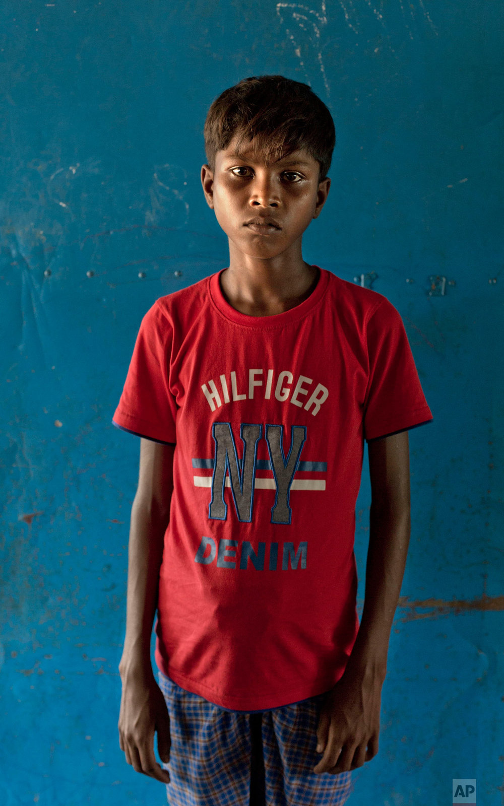  In this Oct. 1, 2017, photo, a Rohingya Muslim boy from Myanmar's Moidaung Village Abdul Gawfar, 13, poses for a photograph inside a transit shelter at Kutupalong camp for newly arrived Rohingya refugees in Bangladesh. His mother drowned when the bo