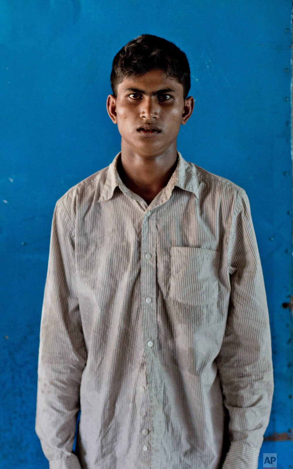  In this Oct. 1, 2017, photo, a 22-year-old Rohingya Muslim Nuro Salam, from Myanmar's Moidaung Village, stands for a photograph inside a classroom of a school serving as a transit shelter at Kutupalong camp for newly arrived Rohingya refugees in Ban