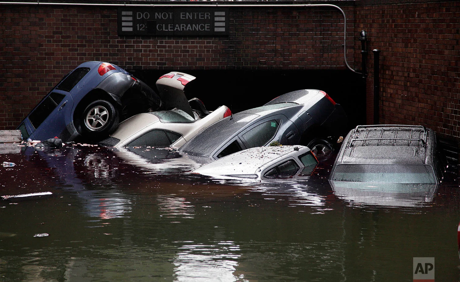 Cars are submerged at the entrance to a parking garage in New York's Financial District in the aftermath of superstorm Sandy, Tuesday, Oct. 30, 2012. New York City awakened Tuesday to a flooded subway system, shuttered financial markets and hundreds of thousands of people without power a day after a wall of seawater and high winds slammed into the city, destroying buildings and flooding tunnels. (AP Photo/Richard Drew)