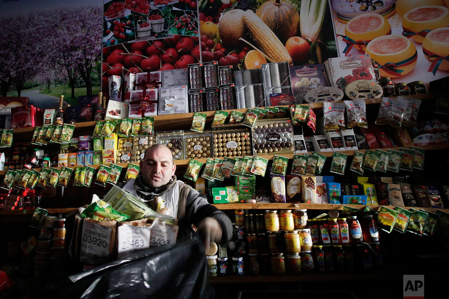 Vitaliy Isakov, manager of Coney Island's Washington Baza supermarket, bags up food items before putting them outside in the garbage, Sunday, Nov. 4, 2012 in New York. Washington Baza supermarket, a Russian-American business, was totally flooded by Superstorm Sandy and all the store's inventory has to b discarded. (AP Photo/Mark Lennihan)