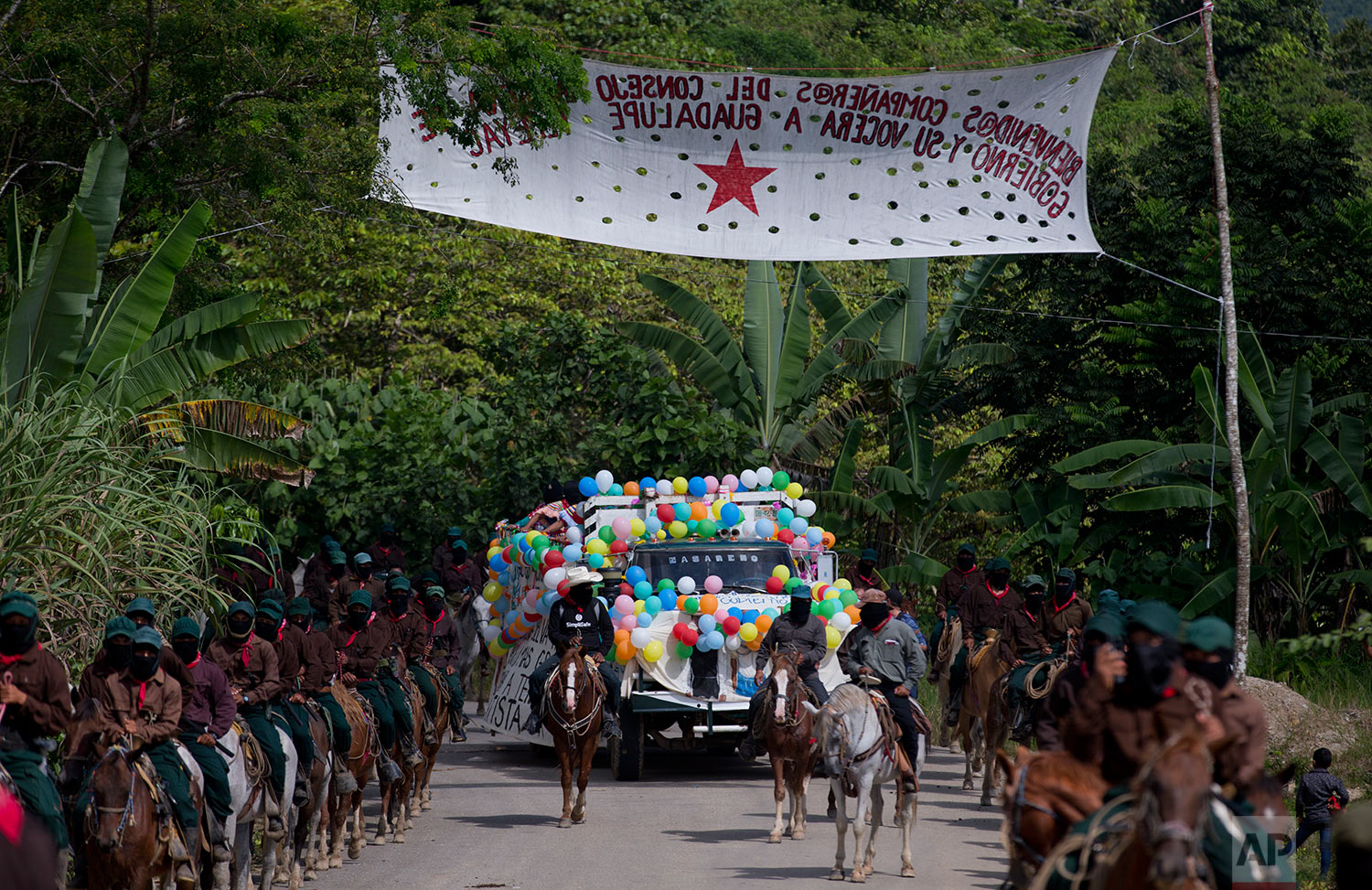  In this Saturday, Oct. 14, 2017 photo, horse riding members of the Zapatista National Liberation Army (EZLN) escort Maria de Jesus Patricio, presidential candidate for the National Indigenous Congress, as she campaigns in the Zapatista stronghold of