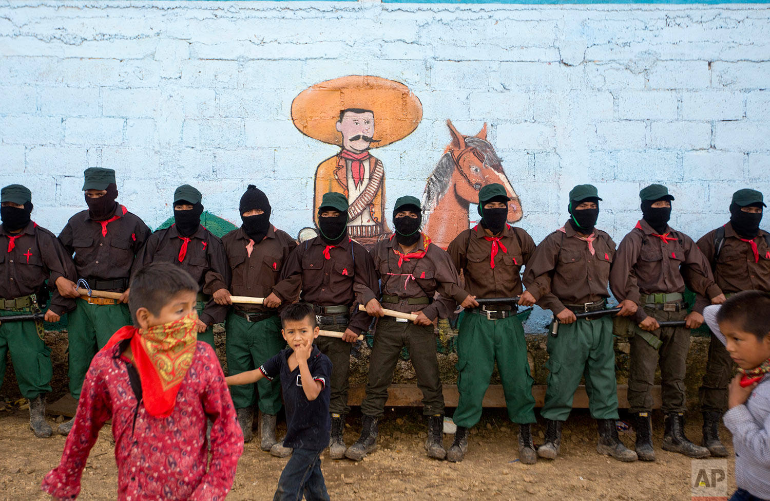  In this Monday, Oct. 16, 2017 photo, members of the Zapatista National Liberation Army (EZLN) provide security for a campaign rally by presidential candidate for the National Indigenous Congress, Maria de Jesus Patricio, in the Zapatista stronghold 