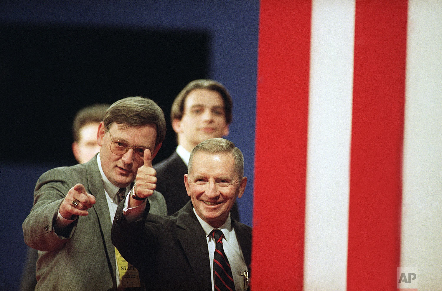  Ross Perot, right, independent candidate for president, gives a thumbs up to the crowd gathered in the Great Hall at Michigan State University, as he walked through the site of the presidential debate in East Lansing, Mich., Oct. 19, 1992. Man at le