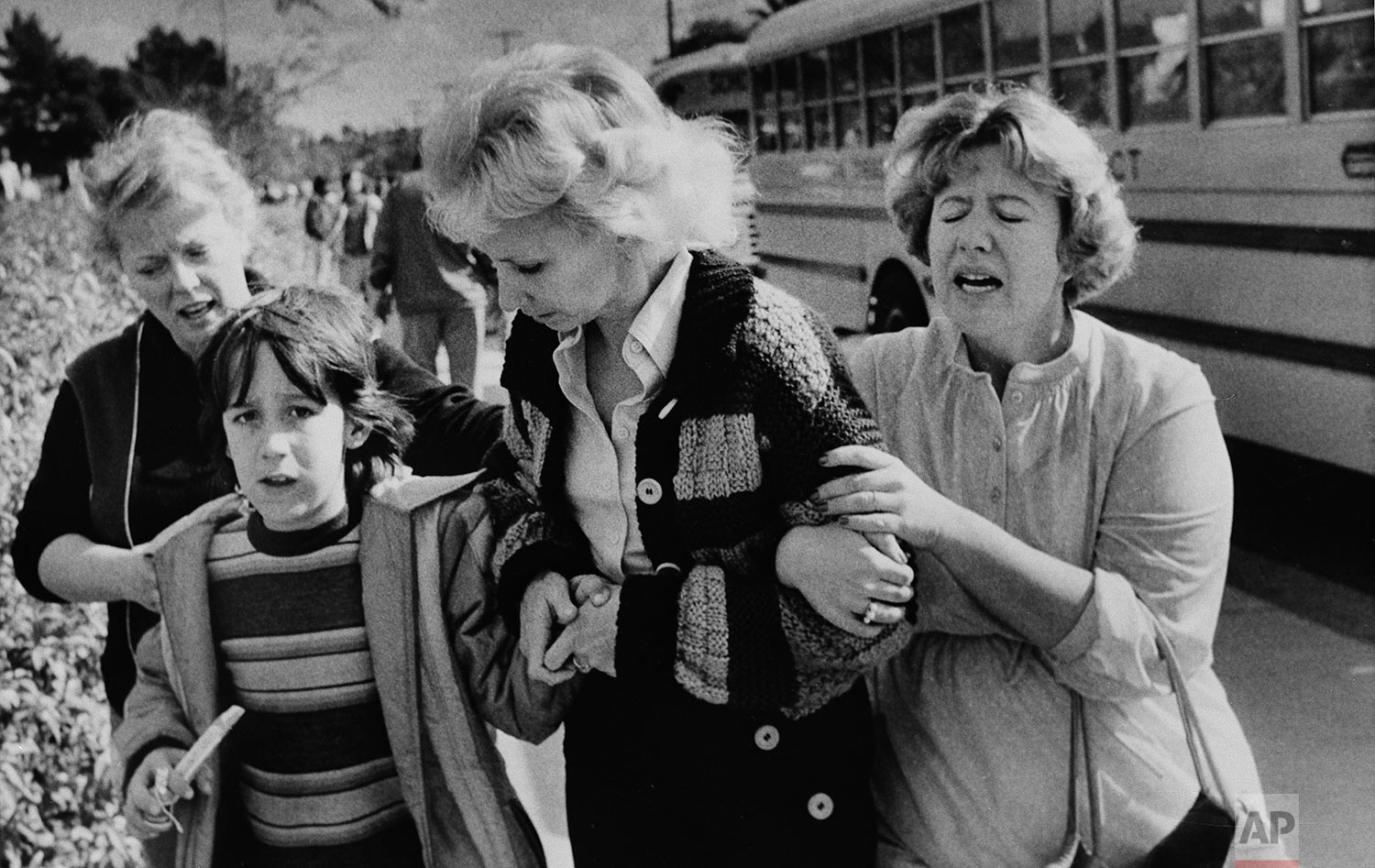  Unidentified women greet a young boy who was evacuated by bus to a nearby junior high school in San Diego from the schoolyard of the Cleveland Elementary School after a sniper opened fire on the schoolyard, Jan. 29, 1979. (AP Photo/Lennox McLendon) 