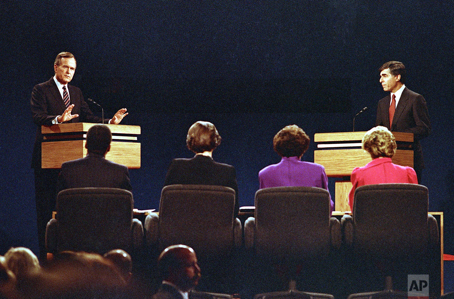 Vice President George Bush (left) gestures while making a point to the panel as Gov. Michael Dukakis watches at right during the second presidential debate on Thursday, Oct. 13, 1988 in Los Angeles. (AP Photo/Lennox McLendon) 
