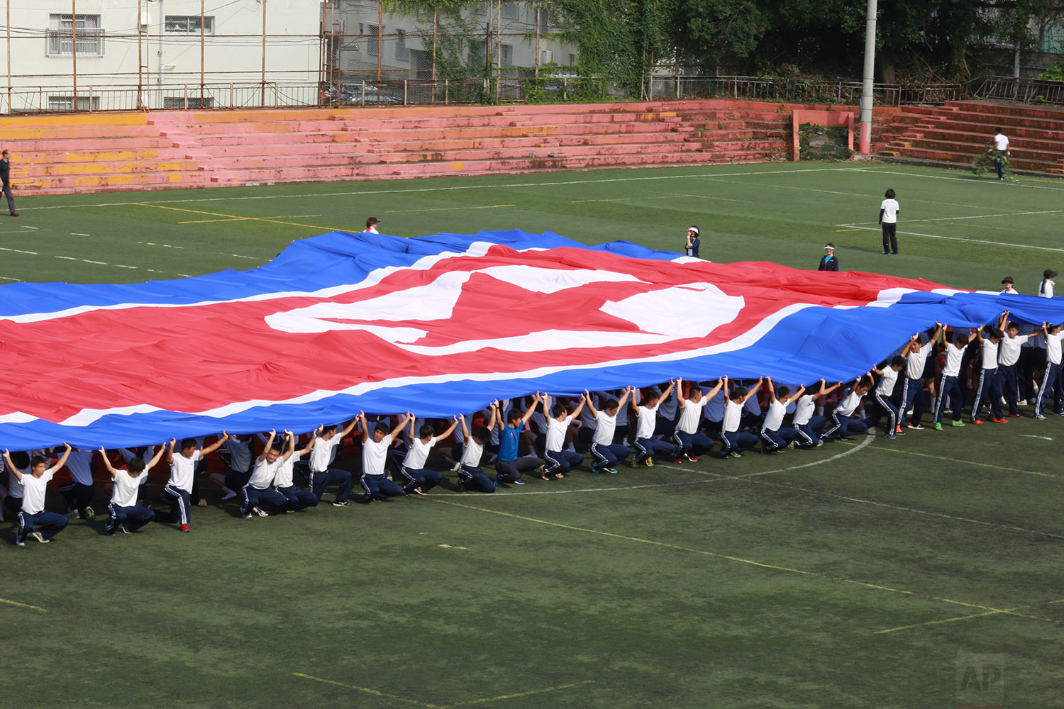  In this Sept. 26, 2017, photo, a student flag team practices a performance waving red, white and blue banners to form th North Korea national flag at a Tokyo Korean high school in Tokyo. (AP Photo/Eugene Hoshiko) 