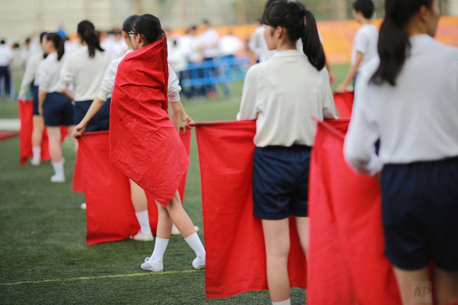  In this Sept. 26, 2017, photo, students practice flag cheering routines at a Korean high school in Tokyo. (AP Photo/Eugene Hoshiko) 