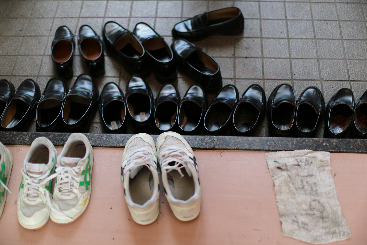  In this Sept. 26, 2017, photo, the shoes of students are placed at the entrance at the schoolhouse of a Korean high school in Tokyo. (AP Photo/Eugene Hoshiko) 