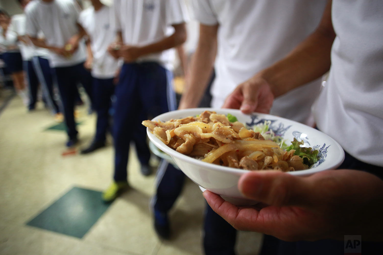  In this Sept. 26, 2017, photo, students line for lunch at a dining hall at a Korean high school in Tokyo. (AP Photo/Eugene Hoshiko) 
