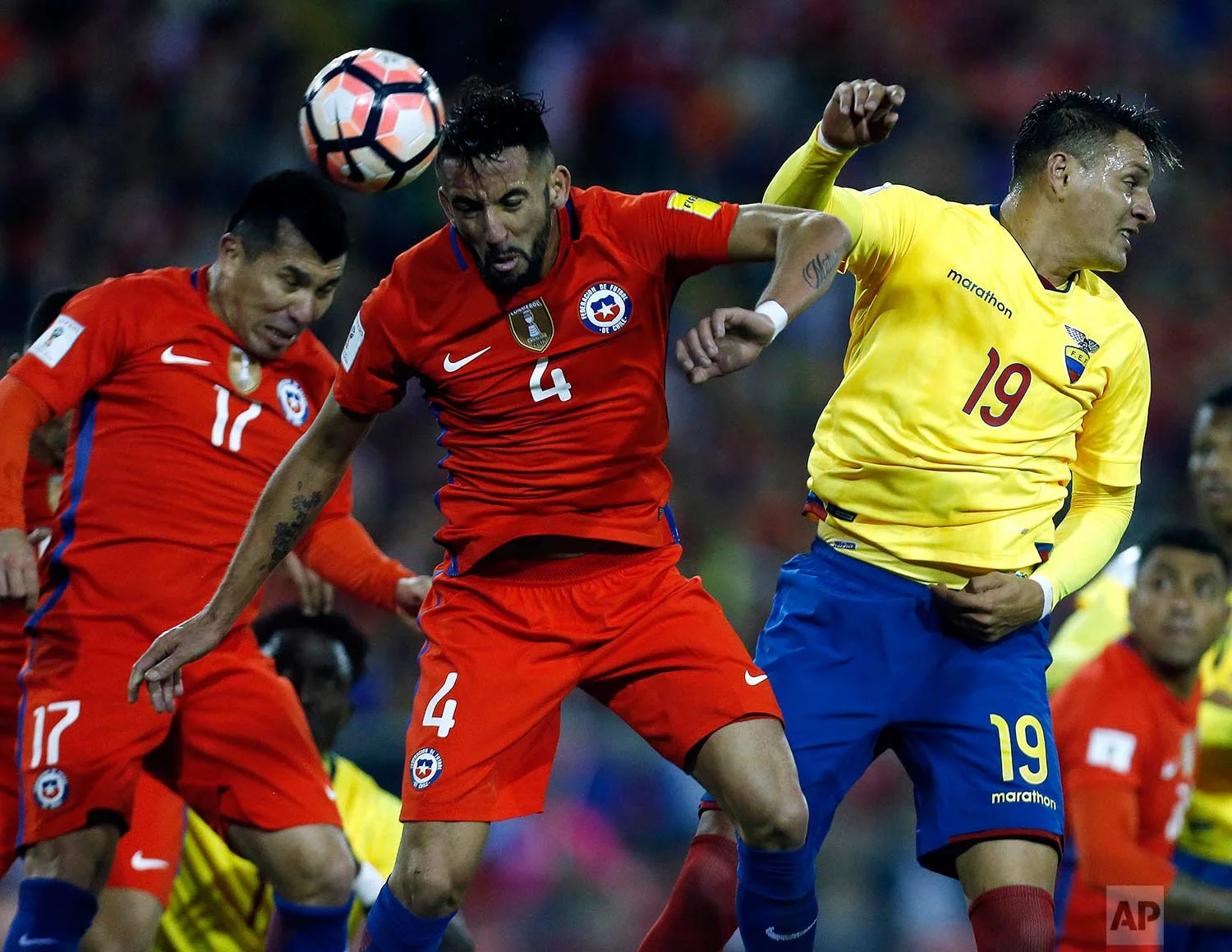 Chile's Mauricio Isla, center, fights to head the ball against Ecuador's Joao Plata Cotera, right, during a 2018 World Cup qualifying soccer match in Santiago, Chile, Thursday, Oct. 5, 2017. (AP Photo/Luis Hidalgo)