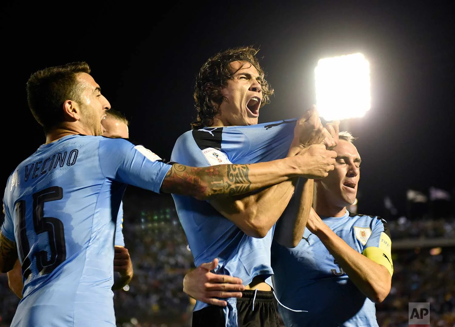 Uruguay's Edinson Cavani, center, celebrates after scoring against Bolivia during a 2018 World Cup qualifying soccer match in Montevideo, Uruguay, Tuesday, Oct. 10, 2017. (AP Photo/Matilde Campodonico)