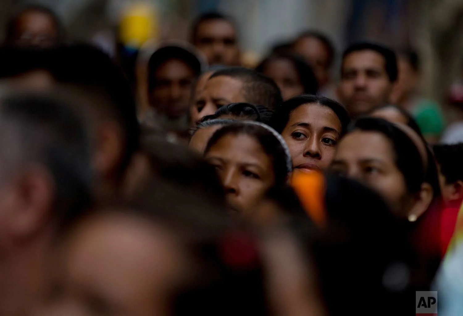 Voters wait in line to cast their ballots outside a polling station during regional elections in Caracas, Venezuela, Sunday, Oct. 15, 2017. (AP Photo/Fernando Llano)