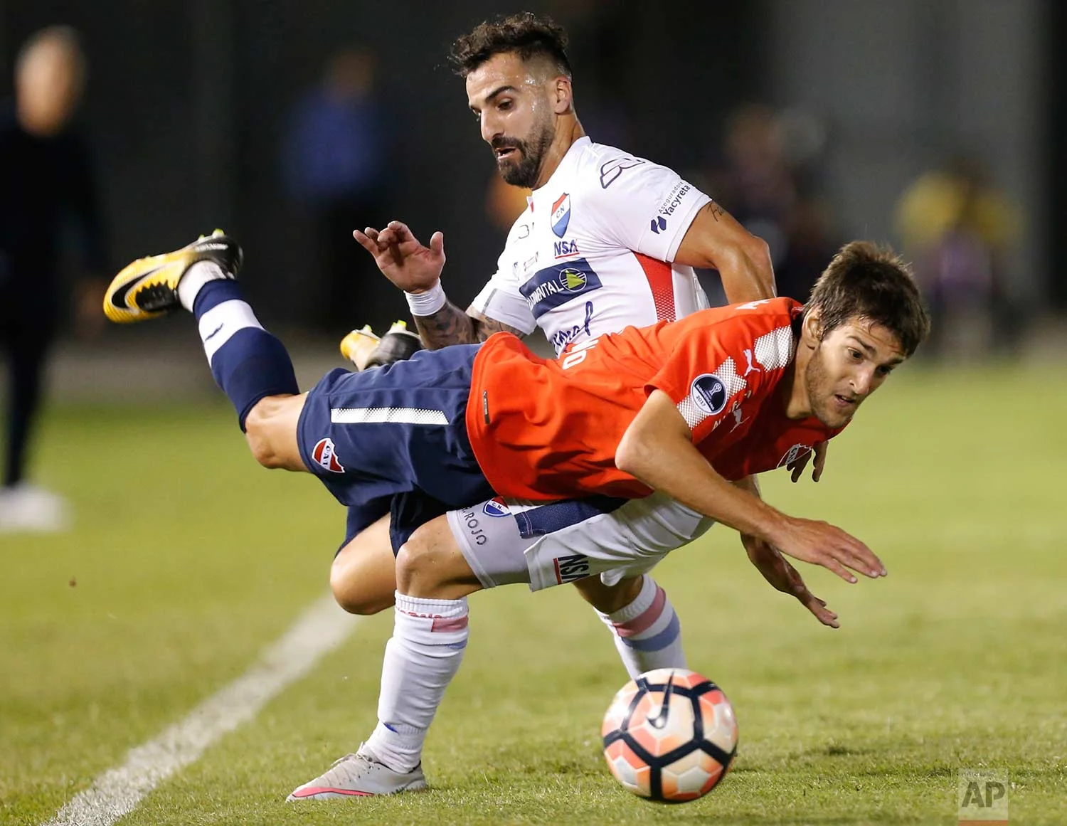 Lucas Albertengo, front, of Argentina's Independiente, fights for the ball with Rodrigo Rojo of Paraguay's Nacional during a Copa Sudamericana quarter final soccer game in Asuncion, Paraguay, Wednesday, Oct. 25, 2017. (AP Photo/Jorge Saenz)