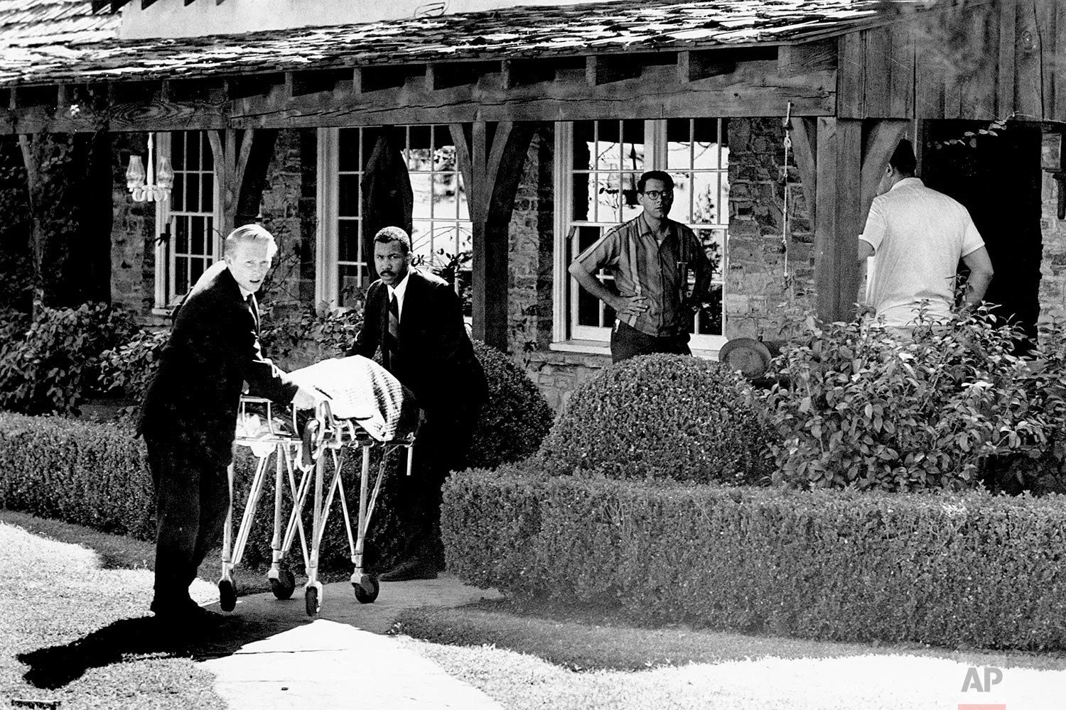 The body of actress Sharon Tate is taken from her rented house on Cielo Drive in Beverly Hills, Calif., on Aug. 9, 1969. Tate, who was eight months pregnant, and four other persons were found murdered by American cult-leader Charles Manson and his followers. Tate, the wife of director Roman Polanski, was born in 1943. (AP Photo)