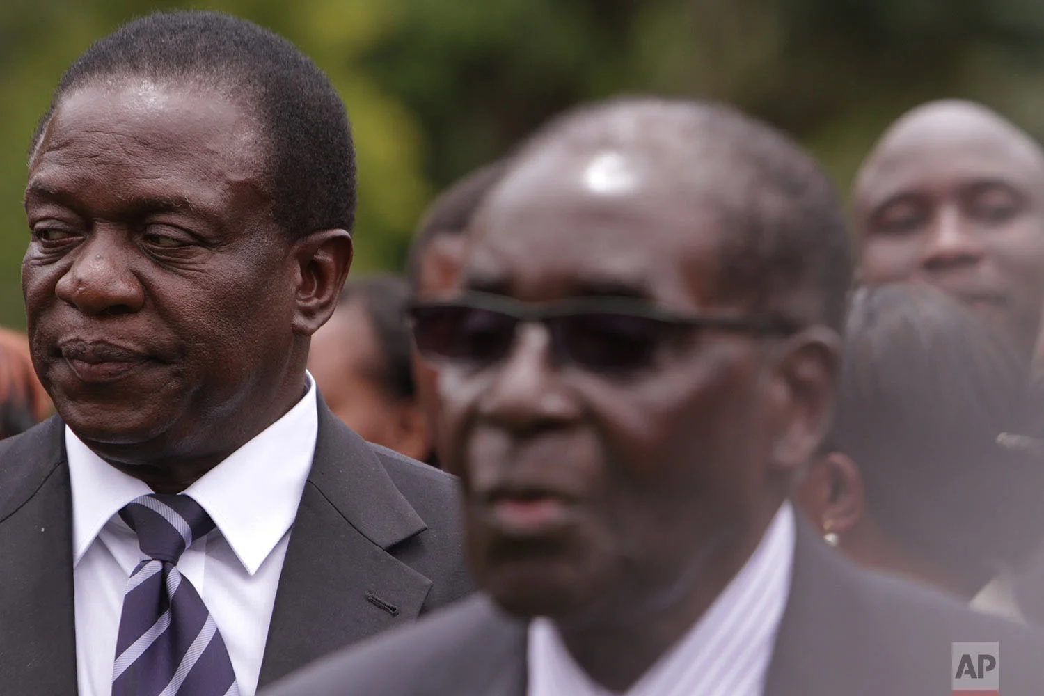 Emmerson Mnangagwa, left, Vice President of Zimbabwe stands next to Zimbabwean President Robert Mugabe after the swearing in ceremony at State House in Harare, Dec, 12, 2014. (AP Photo/Tsvangirayi Mukwazhi)