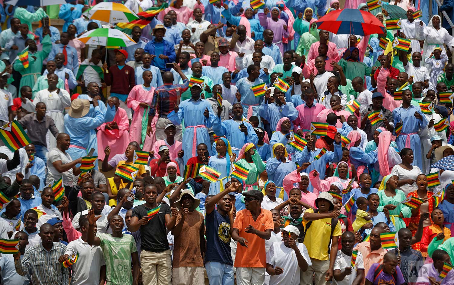  Spectators cheer from the stands at the inauguration ceremony of President Emmerson Mnangagwa in the capital Harare, Zimbabwe Friday, Nov. 24, 2017. Mnangagwa was sworn in as Zimbabwe's president after Robert Mugabe resigned on Tuesday, ending his 3