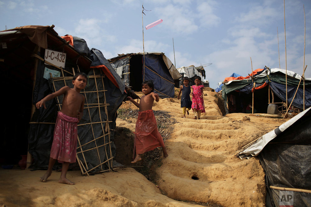  Rohingya children walk to and from tents in Jamtoli refugee camp on Friday, Nov. 24, 2017, in Bangladesh. Since late August, more than 620,000 Rohingya have fled Myanmar's Rakhine state into neighboring Bangladesh, seeking safety from what the milit