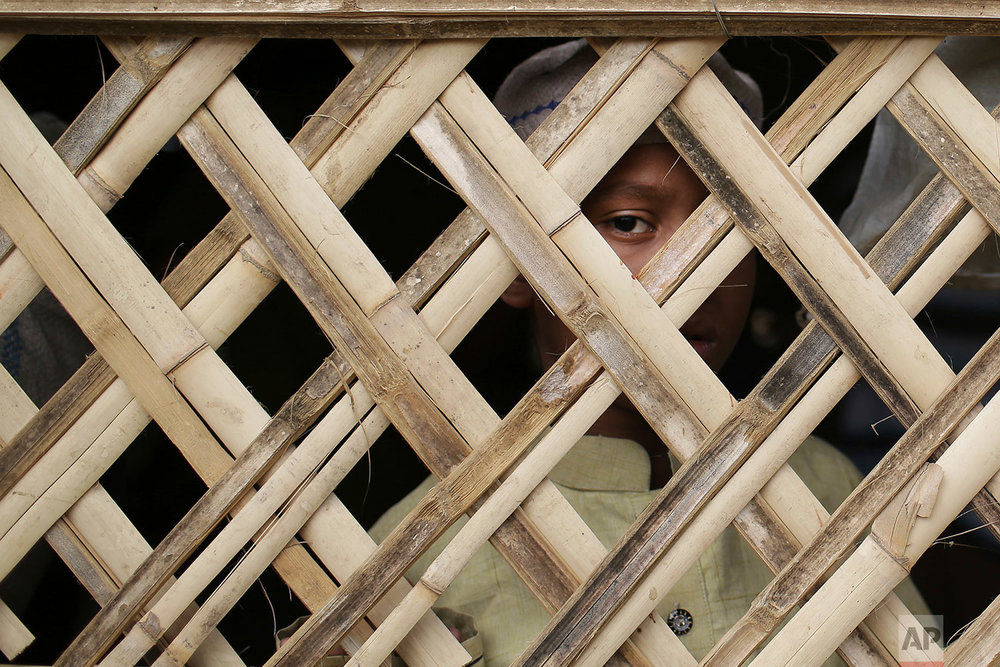  In this Nov. 24, 2017, file photo, a young Rohingya Muslim boy looks out from a makeshift mosque before Friday prayers in Jamtoli refugee camp, in Bangladesh. Since late August, more than 620,000 Rohingya have fled Myanmar's Rakhine state into neigh