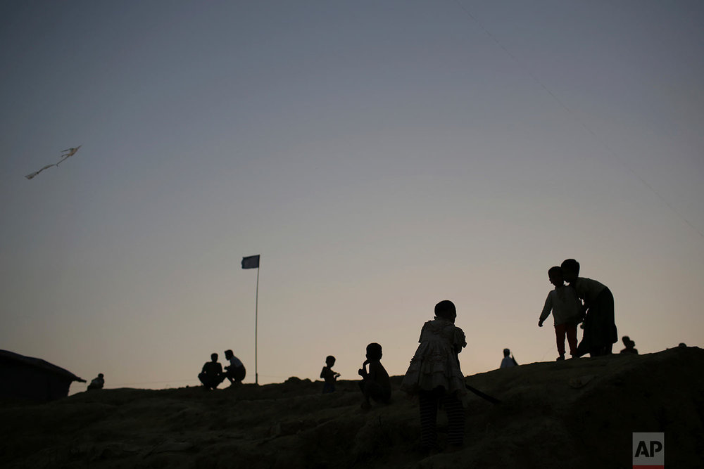  Rohingya Muslim children are silhouetted against the dusk sky in Jamtoli refugee camp on Monday, Nov. 27, 2017, in Bangladesh. Since late August, more than 620,000 Rohingya have fled Myanmar's Rakhine state into neighboring Bangladesh, where they ar