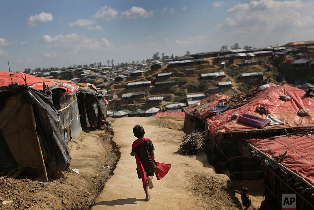  In this Sunday, Nov. 19, 2017, photo, a Rohingya Muslim child runs on a dirt track between tents at Kutupalong refugee camp in Bangladesh.  More than 620,000 Rohingya have fled Rakhine for neighbouring Bangladesh since late August 2017, when the mil