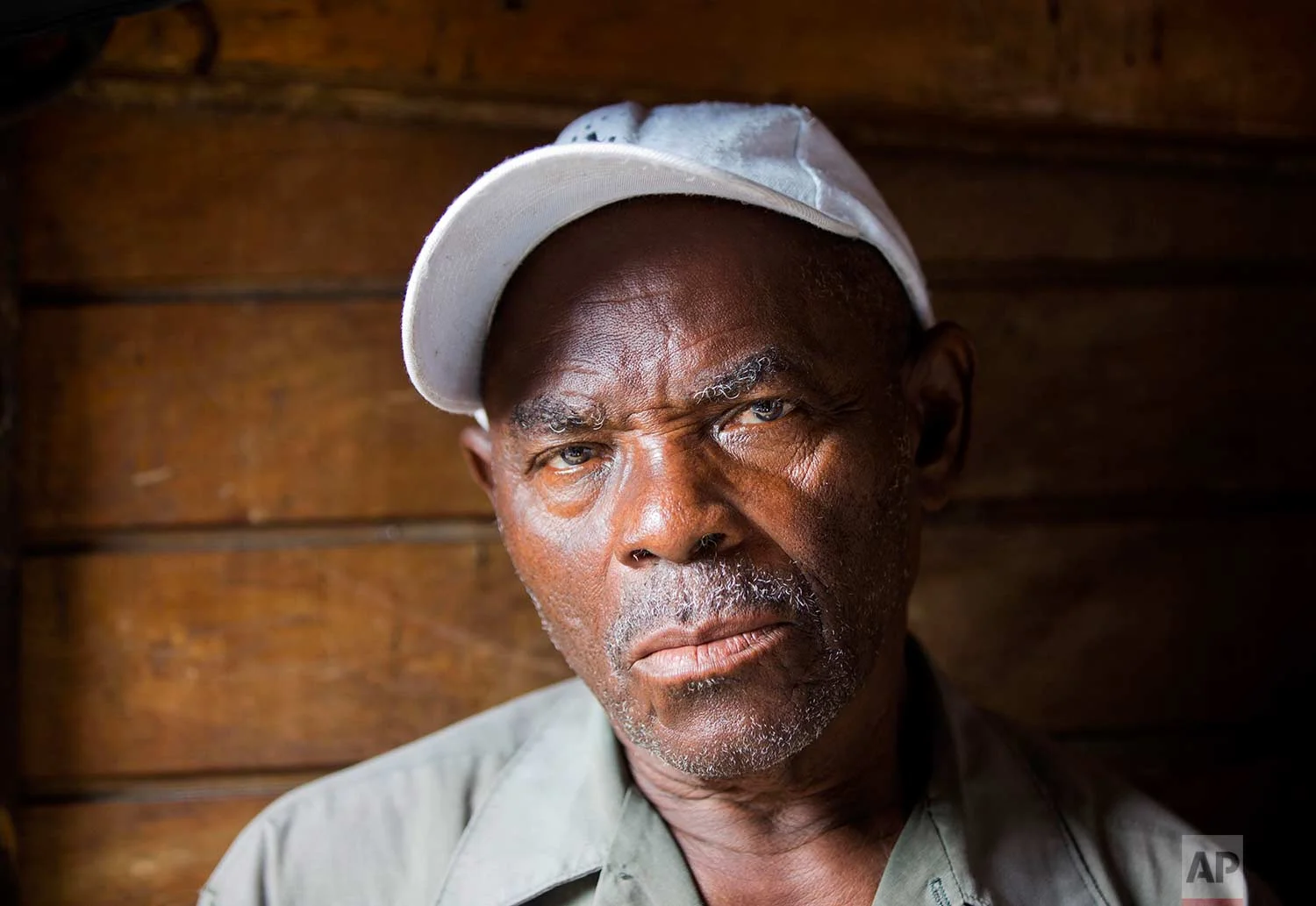 In this Nov. 22, 2017 photo, owner of the La Saline slaughterhouse Polynice Amboise poses for a photo at his open-air market, in Port-au-Prince, Haiti. “The authorities don't come. I bring all my papers to City Hall but they never get back to me,” Amboise said. “I am not happy with the situation of the market. The workers also are not happy.”(AP Photo/Dieu Nalio Chery)