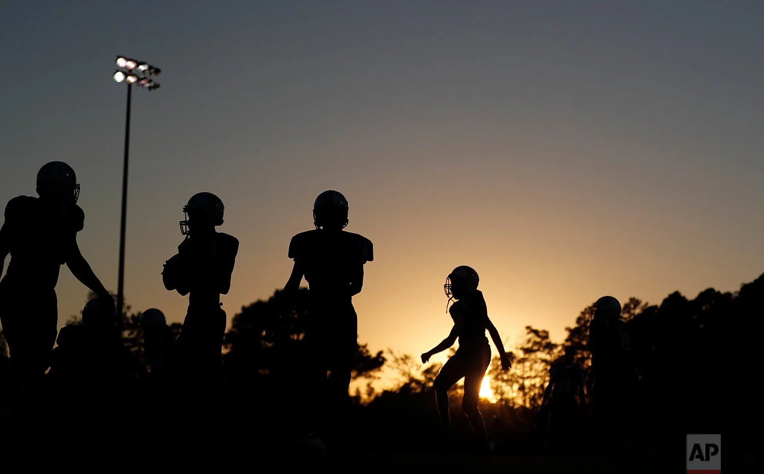 South Robeson High School football players warm up before a game in Rowland, N.C., Friday, Oct. 27, 2017. (AP Photo/David Goldman)