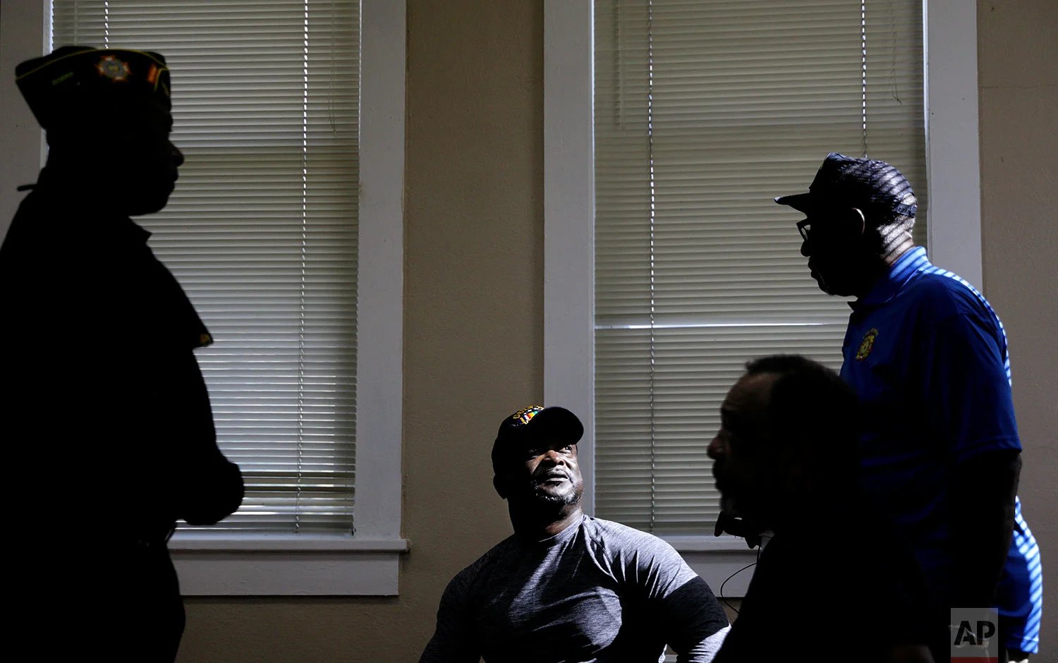 U.S. Army Gulf War veteran Robert Tolbert, center, who supports the protests of kneeling during the national anthem, speaks with fellow veterans at a Veterans of Foreign Wars meeting in Lumberton, N.C., Saturday, Oct. 28, 2017. "Everybody's mad at each other because everybody's got their opinion on this," Tolbert bemoaned to the group of mostly African-American war veterans, and recounted the exchange. "I said, 'look brother, we've got to understand why we came into the military, why we fought for this. Don't let the media and politicians divide us because we all believe in the same thing - we believe in justice, we believe in freedom of speech - because that's what we fought for. Isn't it?" (AP Photo/David Goldman)