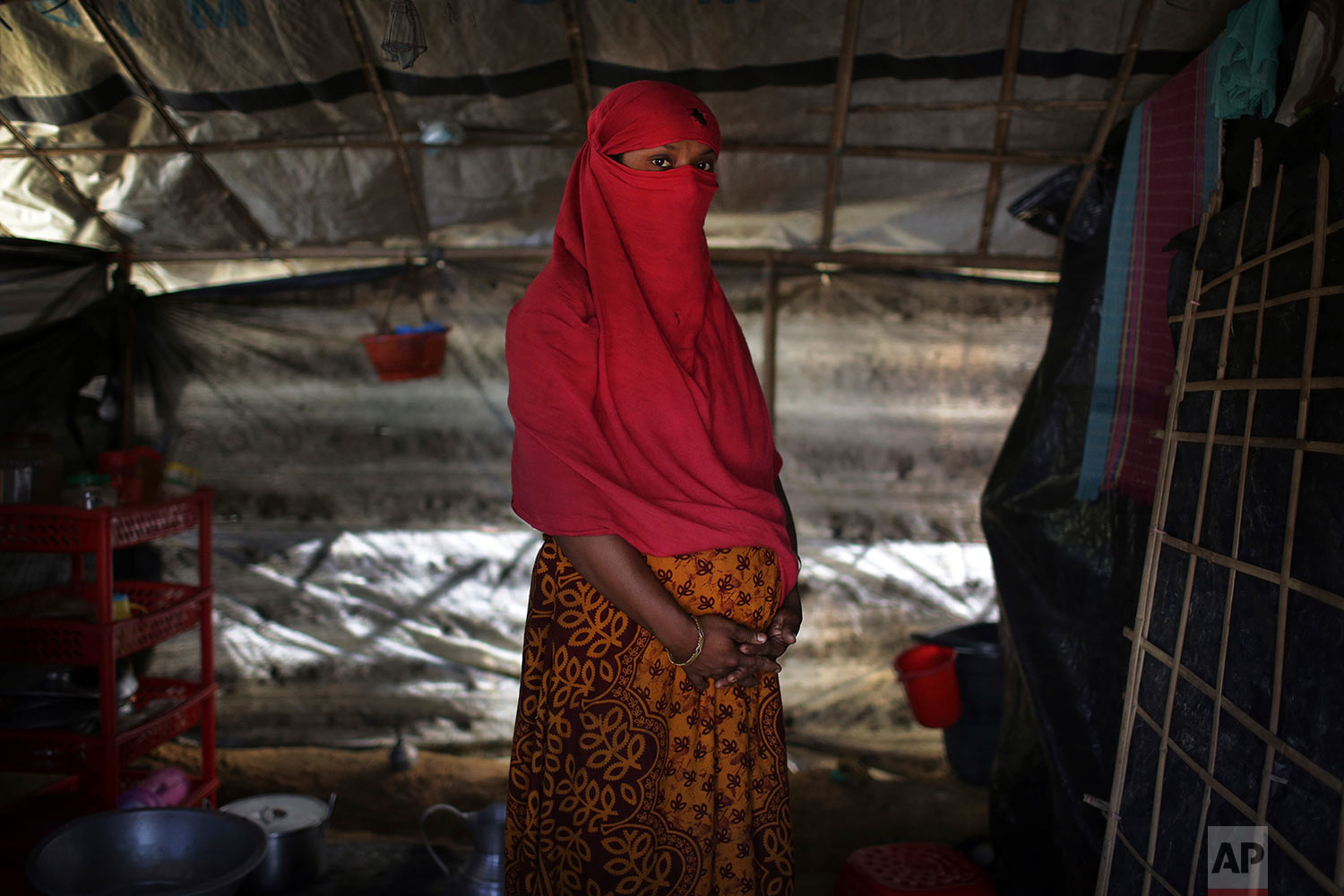  In this Monday, Nov. 20, 2017, photo, F, 22, who says she was raped by members of Myanmar's armed forces in June and again in September, clutches her hands around her pregnant belly as she is photographed in her tent in Kutupalong refugee camp in Ba