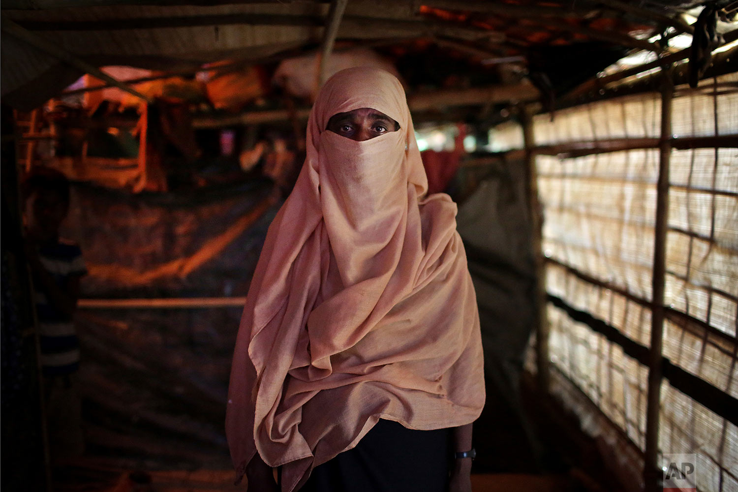  In this Sunday, Nov. 19, 2017, photo, A, 35, mother of four, who says she was raped by members of Myanmar's armed forces in late August, is photographed in her friend's tent in Kutupalong refugee camp in Bangladesh.  (AP Photo/Wong Maye-E)

 