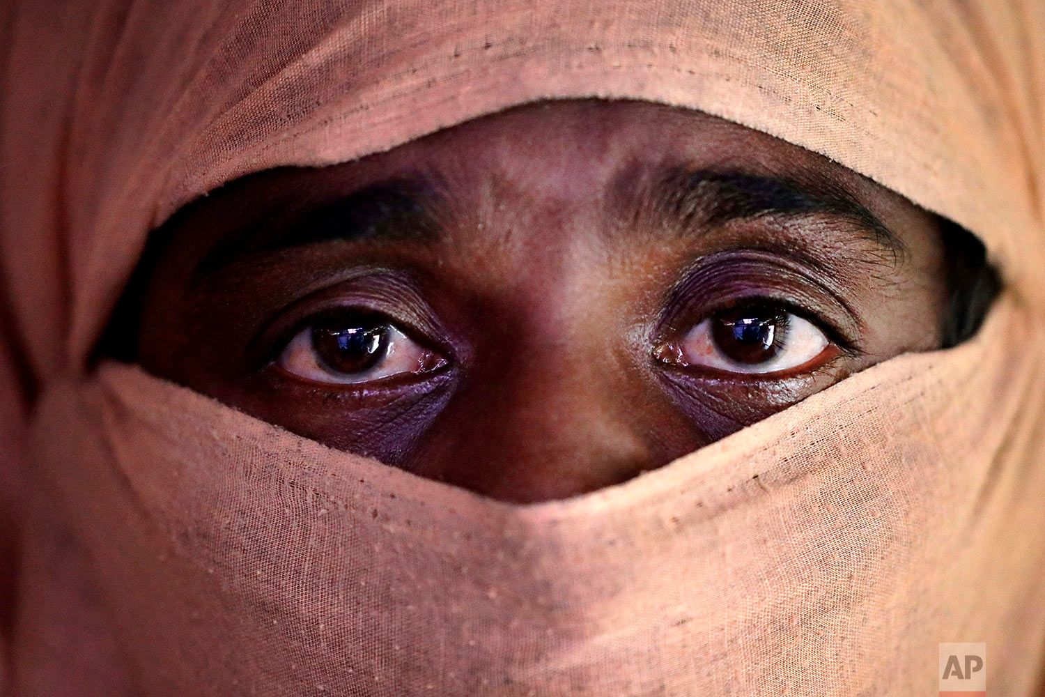  In this Sunday, Nov. 19, 2017, photo, A, 35, mother of four, who says she was raped by members of Myanmar's armed forces in late August, is photographed in her friend's tent in Kutupalong refugee camp in Bangladesh.  (AP Photo/Wong Maye-E)

 