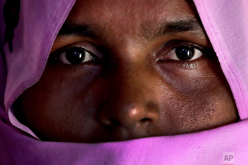  In this Sunday, Nov. 19, 2017, photo, H, 30, mother of six; three children killed, who says she was raped by members of Myanmar's armed forces in late August, is photographed in her friend's tent in Kutupalong refugee camp in Bangladesh.  (AP Photo/
