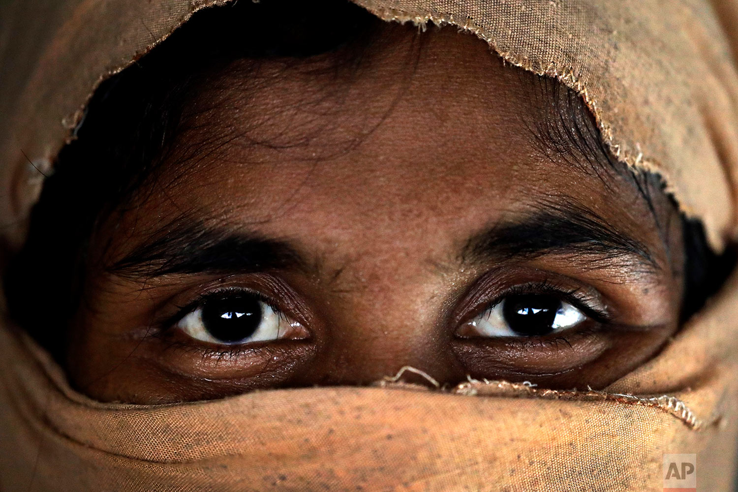  In this Monday, Nov. 20, 2017, photo, S, 25, mother of two, who says she was raped by members of Myanmar's armed forces in late August, is photographed in her friend's tent in Kutupalong refugee camp in Bangladesh.  (AP Photo/Wong Maye-E)

 