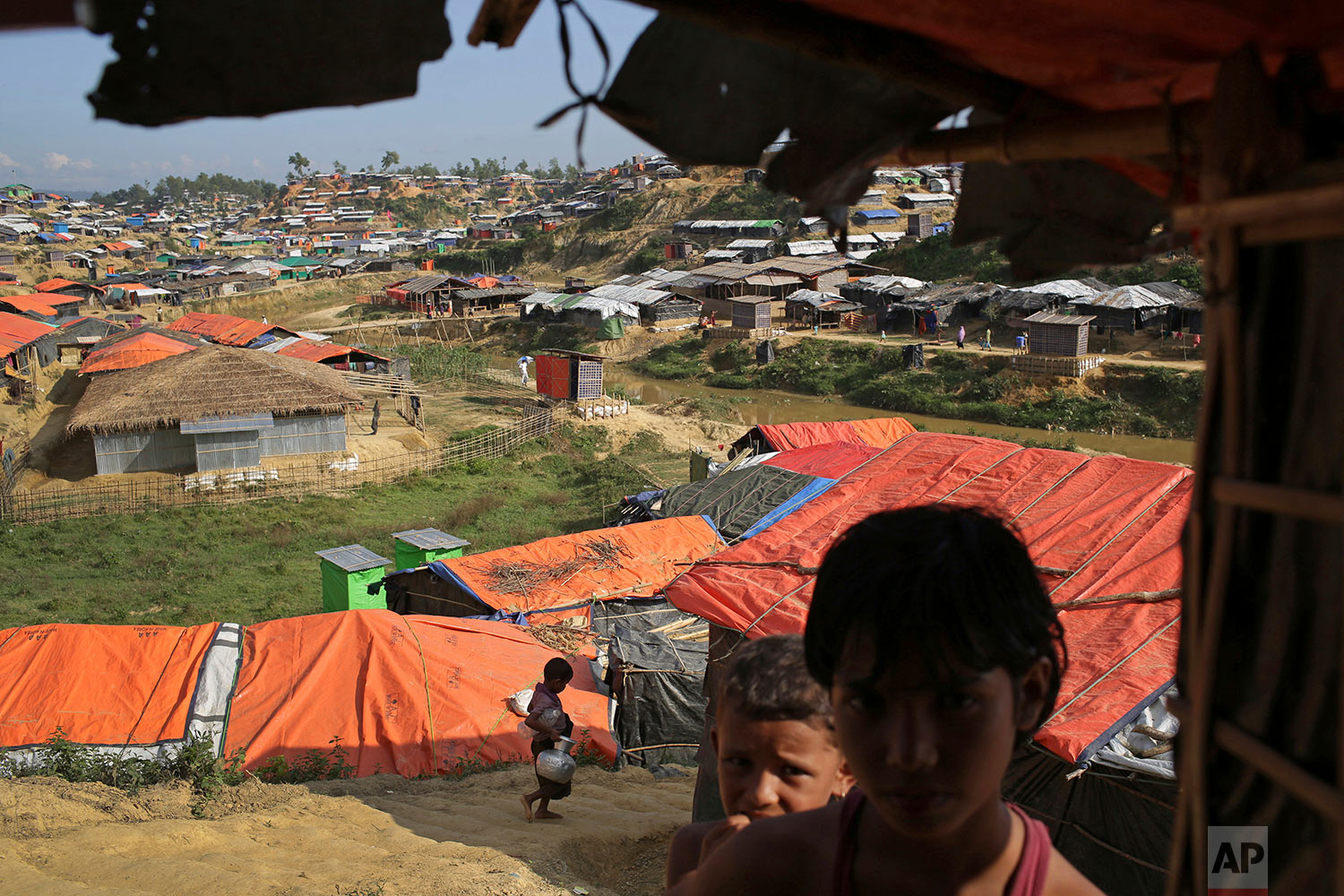  In this Sunday, Nov. 19, 2017, photo, Rohingya children stand in the shade of a tent in Kutupalong refugee camp in Bangladesh. (AP Photo/Wong Maye-E) 