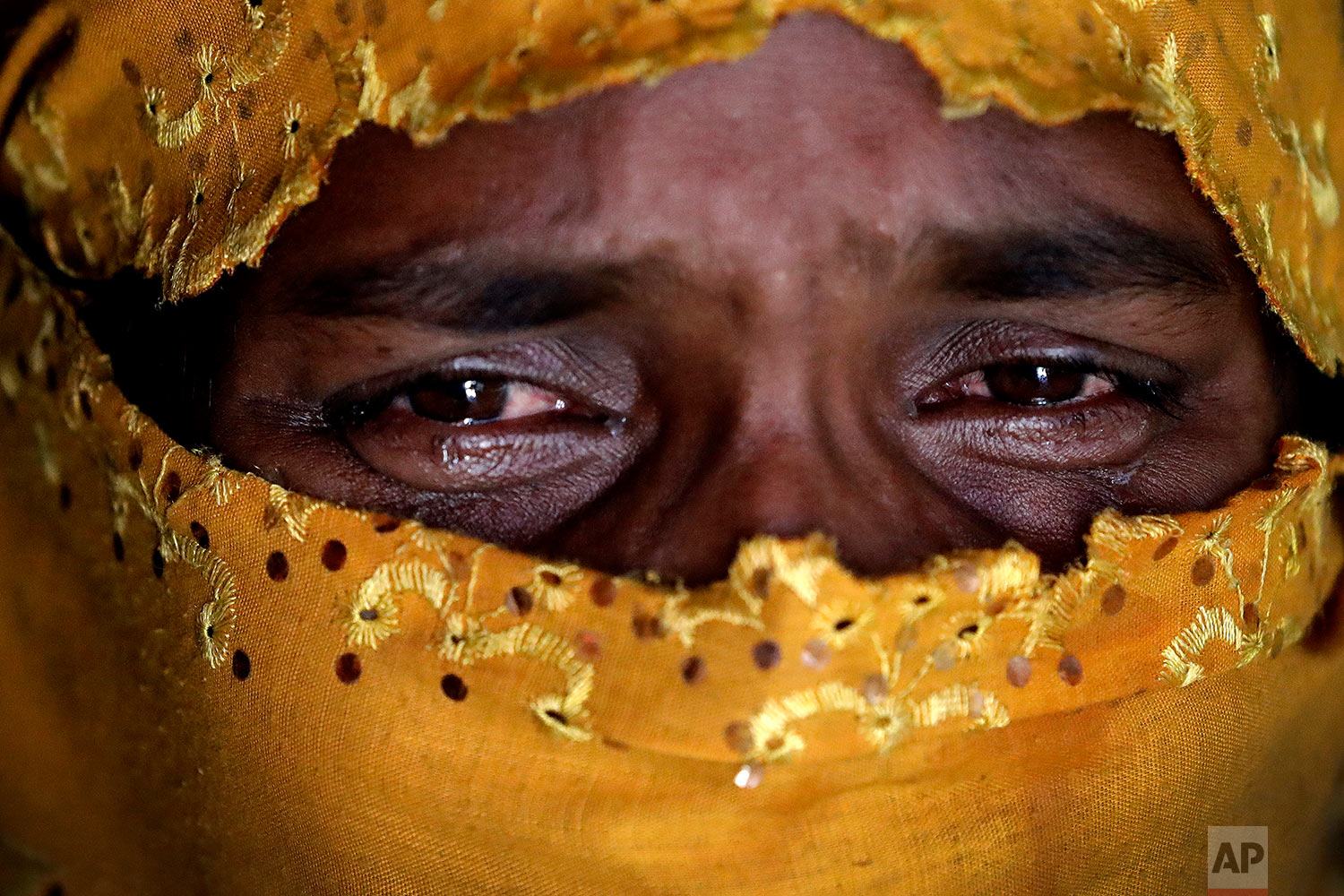  In this Tuesday, Nov. 21, 2017, photo, K, 25, right, cries as she recounts being gang raped by members of Myanmar's armed forces during an interview with The Associated Press in her tent in Kutupalong refugee camp in Bangladesh. (AP Photo/Wong Maye-