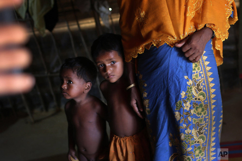  In this Sunday, Nov. 19, 2017, photo, K, 25, right, speaks to The Associated Press while her children watch cautiously beside her in their tent in Kutupalong refugee camp in Bangladesh.&nbsp; (AP Photo/Wong Maye-E) 